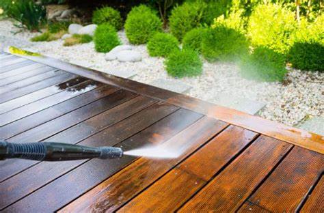 An image of a wooden deck being pressure washed.